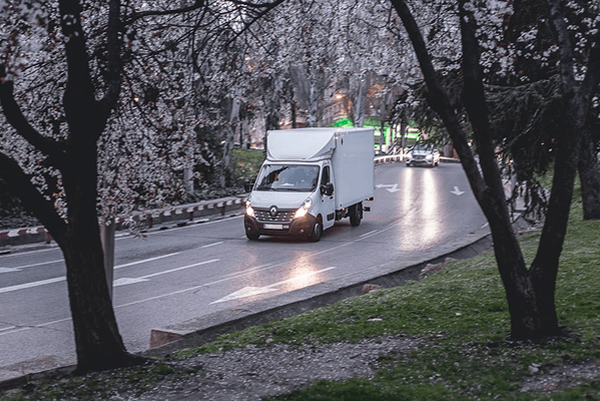 Delivery van driving on wet road